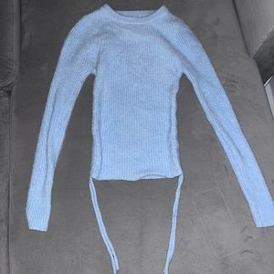 Light blue, long sleeve, VERY soft and fuzzy, crop top with ties on the side.